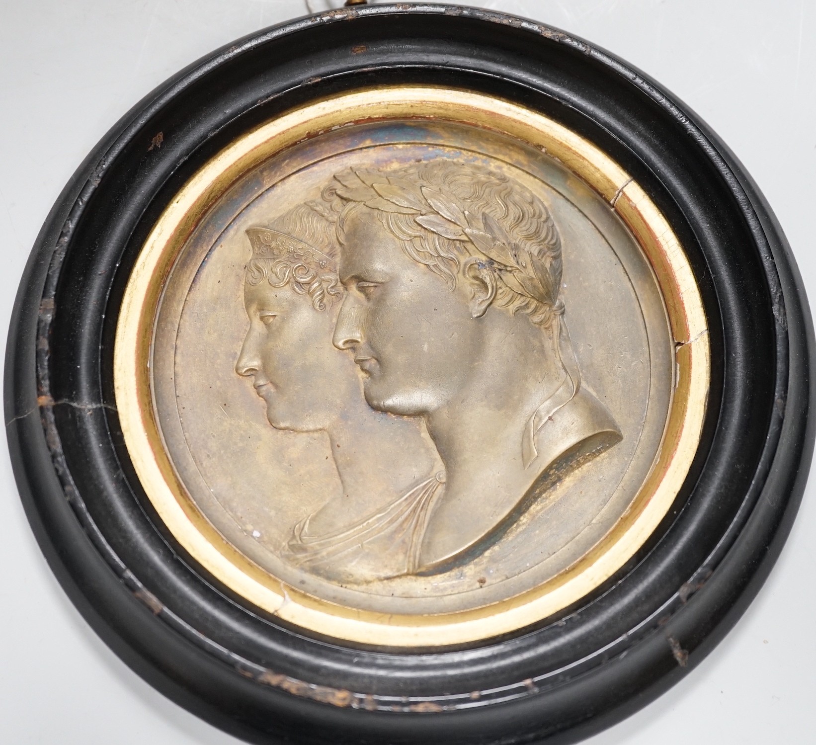 After Bertrand Andrieu (1761-1822). A framed circular gilt brass relief plaque of Napoleon Bonaparte and Marie Louise, Duchess of Parma: signed lower right of bust 'Andrieu Fecit', 14cm diameter excl frame